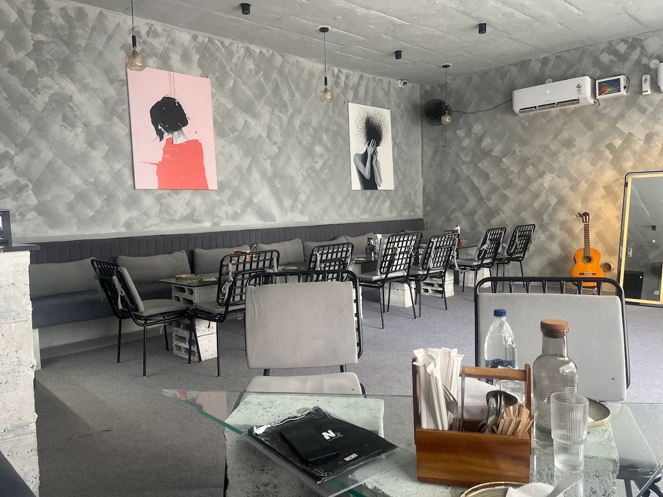 RAW Cafe seating with concrete walls and pop-art prints