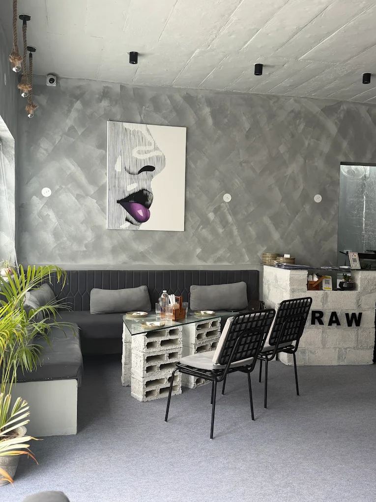 RAW Cafe concrete interior with cinder-block signage and gallery wall