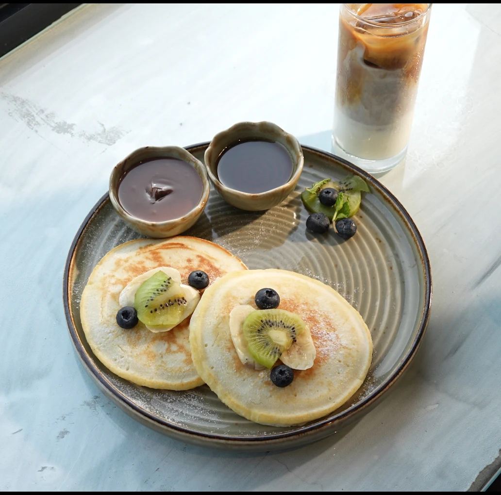 Pancakes with fruit and iced coffee